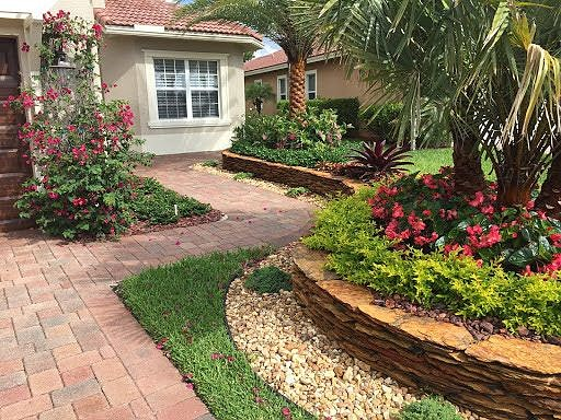 A retaining wall next to a driveway constructed by professional installers in Palm Beach County, FL