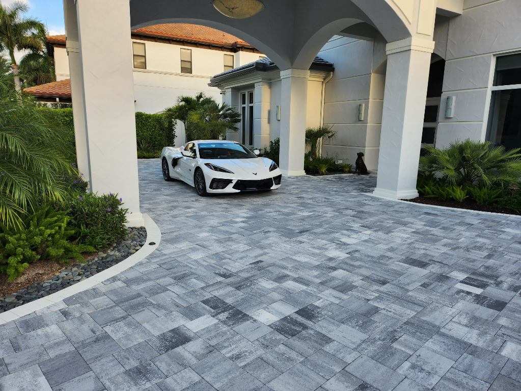 A luxury home with driveway pavers that enhance its curb appeal
