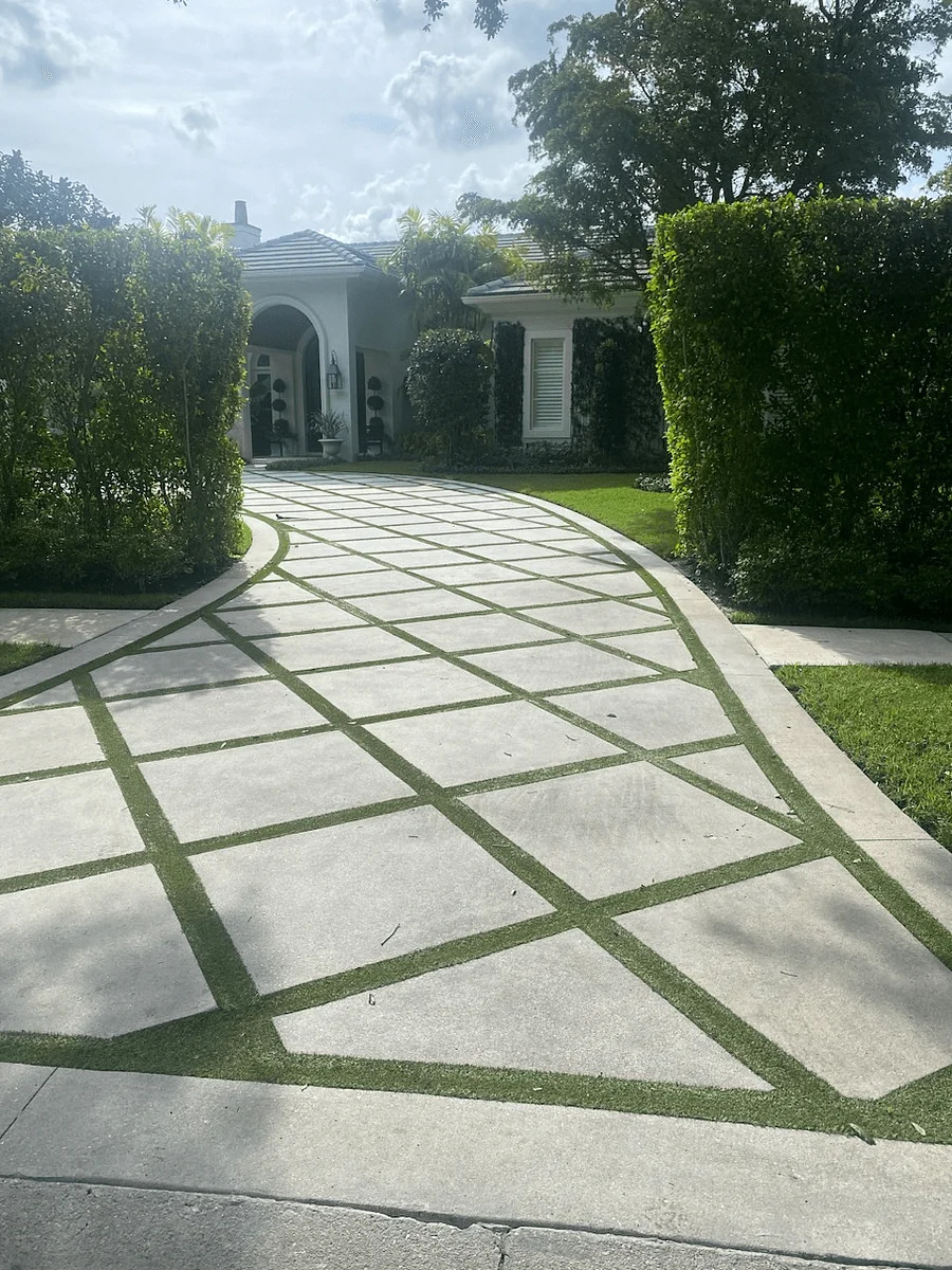 Sophisticated driveway with large concrete slabs installed by driveway paver contractors in Palm Beach County, FL