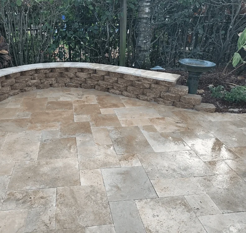 A curved brick retaining wall surrounding a patio