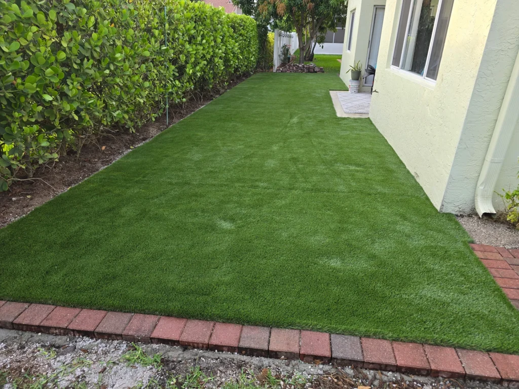 Artificial turf in a backyard installed by contractors in Palm Beach County, FL
