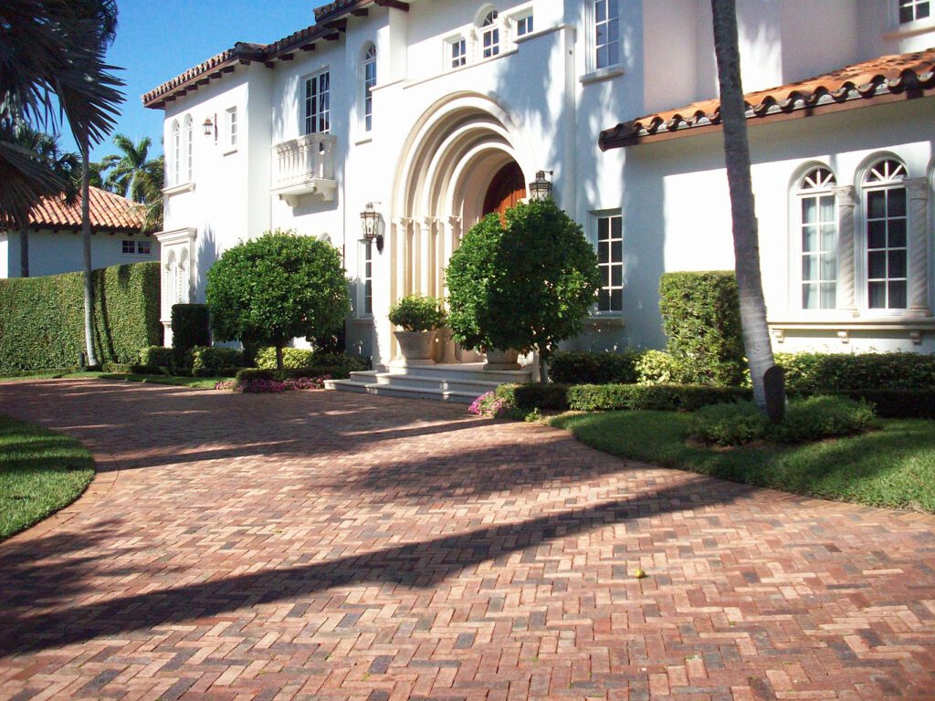 clay driveway pavers in front of a large white house
