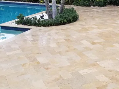 Contractors built travertine pavers around pool patio