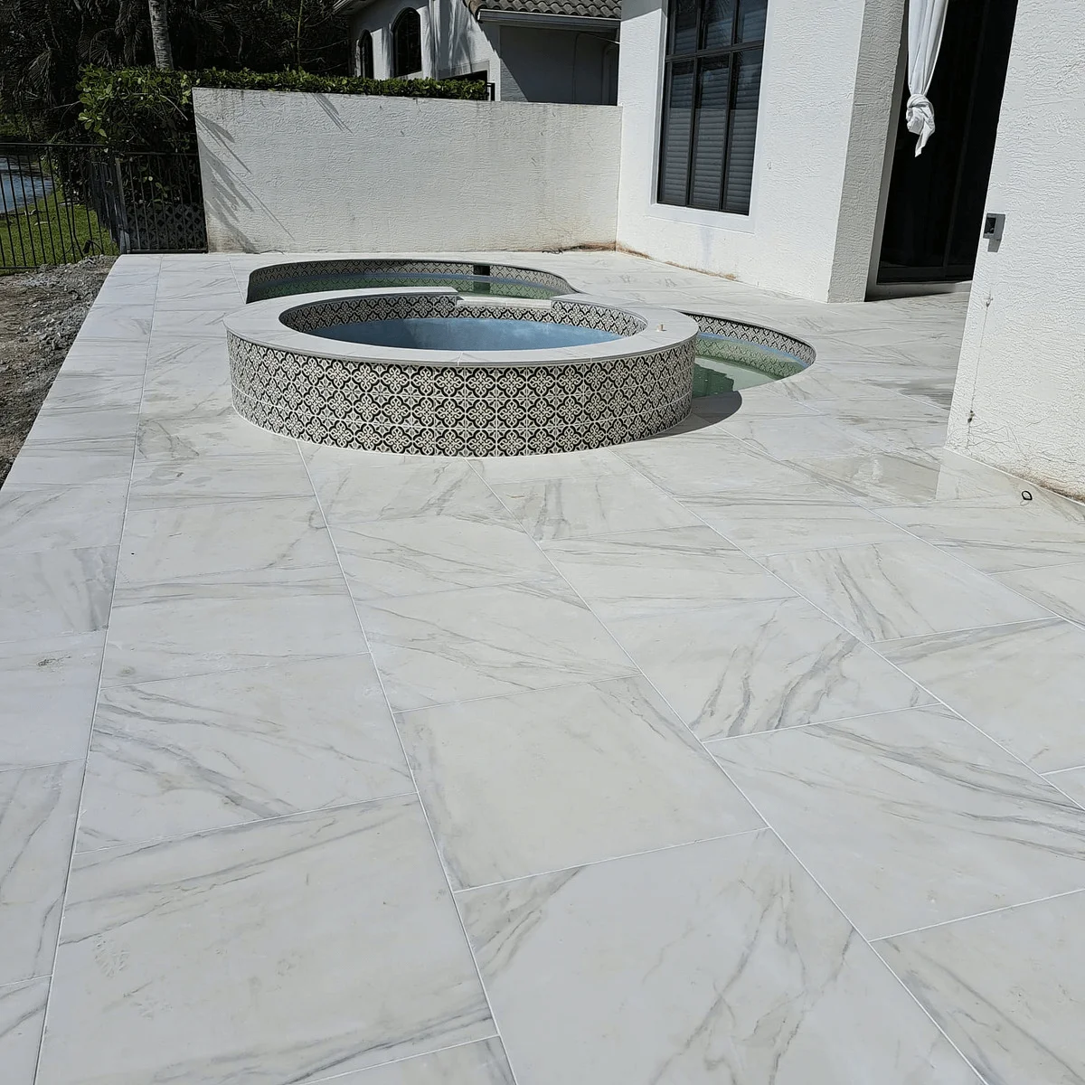 Porcelain patio paver installation around jacuzzi in Palm Beach County, FL
