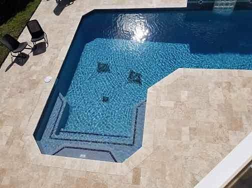 Completed job by porcelain paver installers around a Palm Beach County, FL, pool