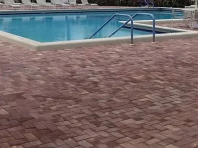 A swimming pool with pavers installed by professional services in Delray Beach, FL