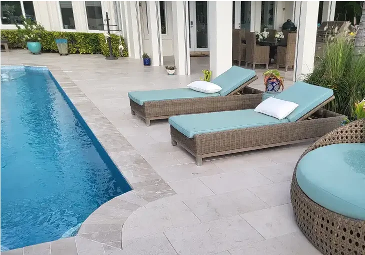 A pool deck with gray pavers installed by paver installers in Palm Beach County, Florida
